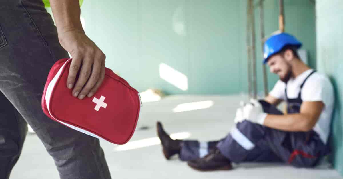 Construction worker holding first aid kit
